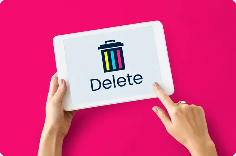 person tap delete on laptop